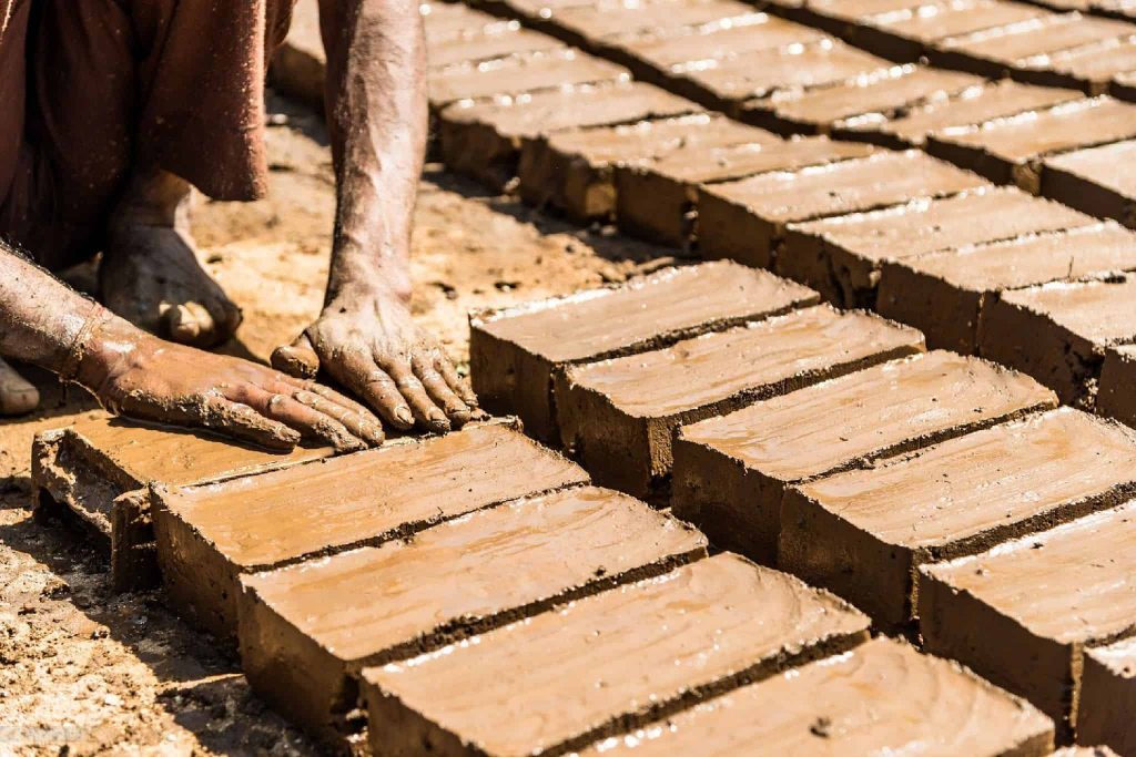 Picture of a man making clay bricks