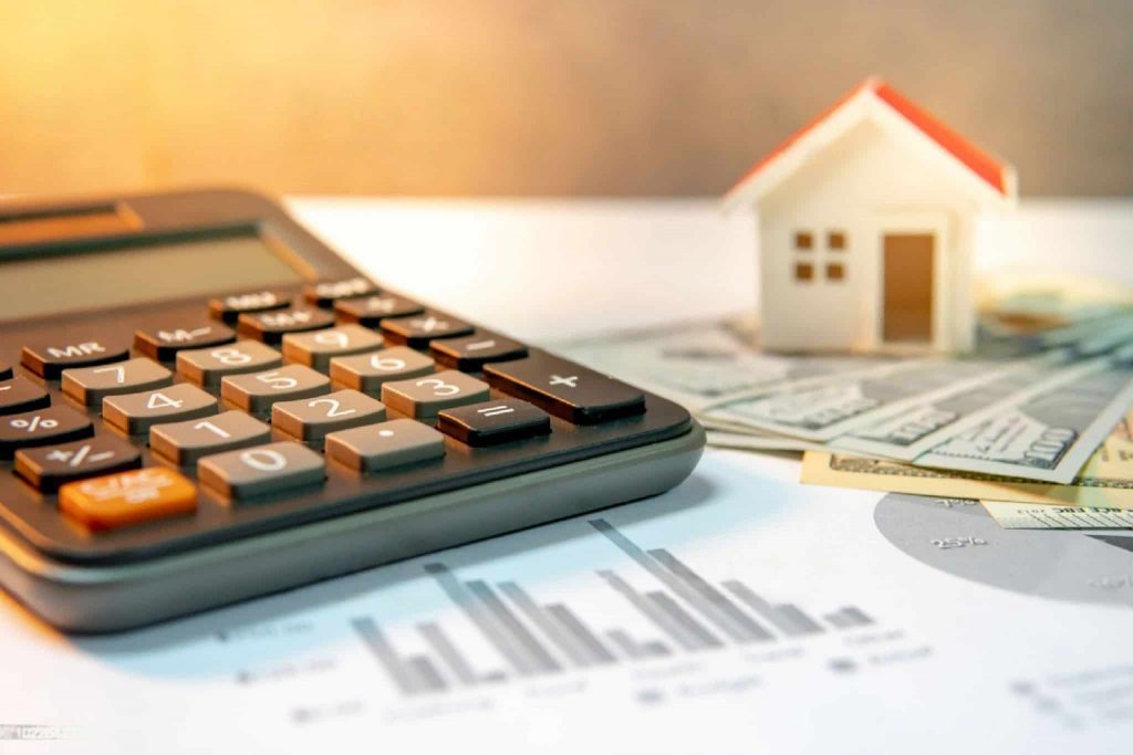 Picture of a small house and calculator on a construction proposal