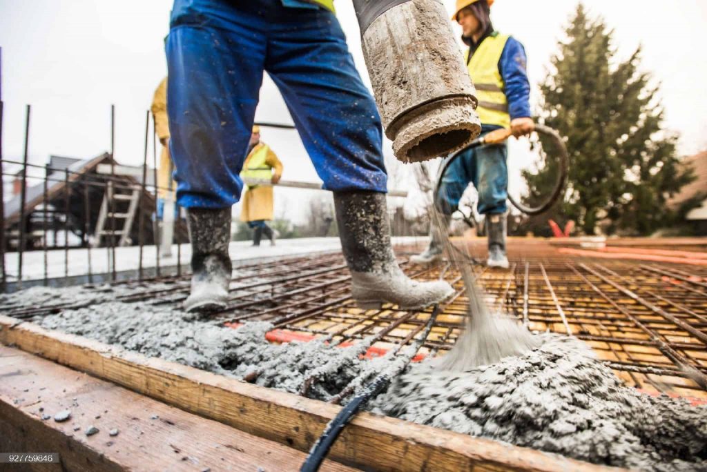 Picture of a construction worker setting up concrete at a construction site