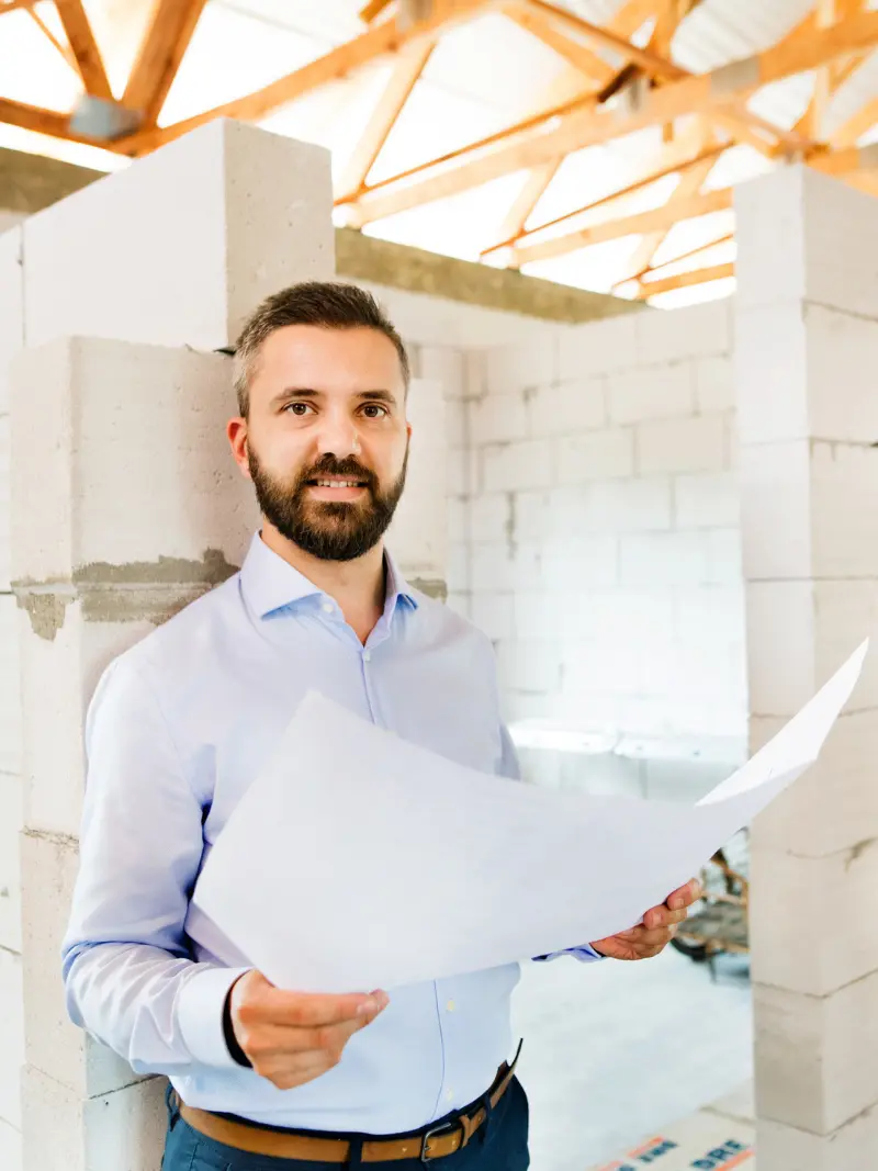 Interior designer reviewing project plans on site